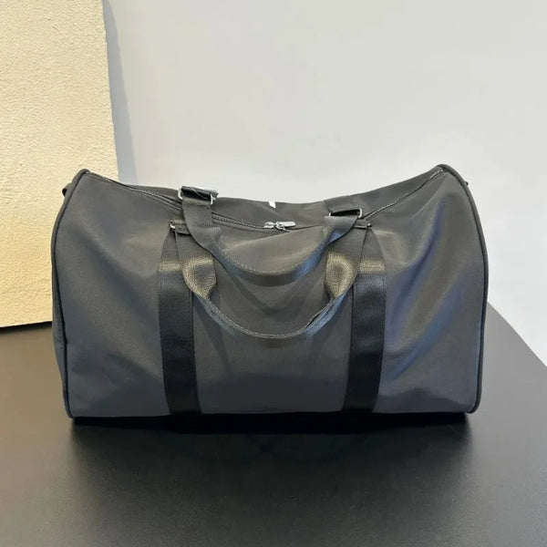 Black urban travel gym bag with dual handles and adjustable shoulder strap