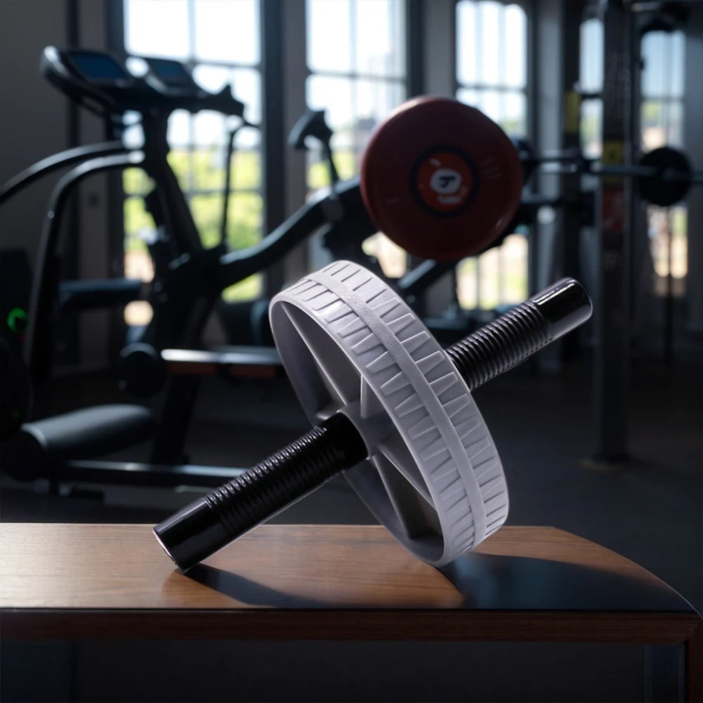 Professional ab roller wheel with dual foam grip handles displayed in home gym setting for core strength training