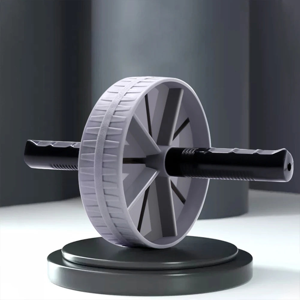 Gray ab roller wheel with textured tread and black foam handles displayed on platform showing stable wide-base design