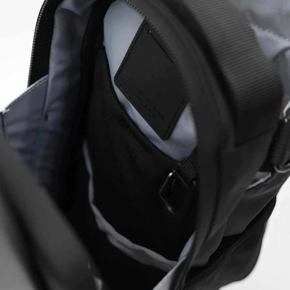 Black gym bag interior showing zippered pocket and gray lining